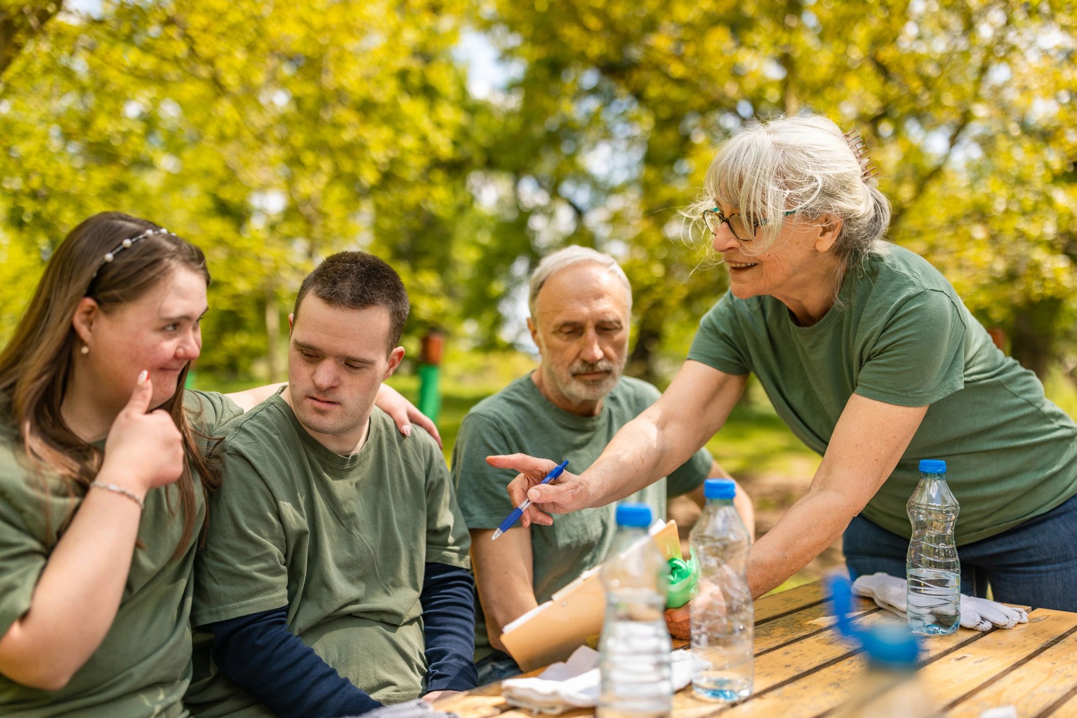 Adult volunteers talking together outdoors during a break