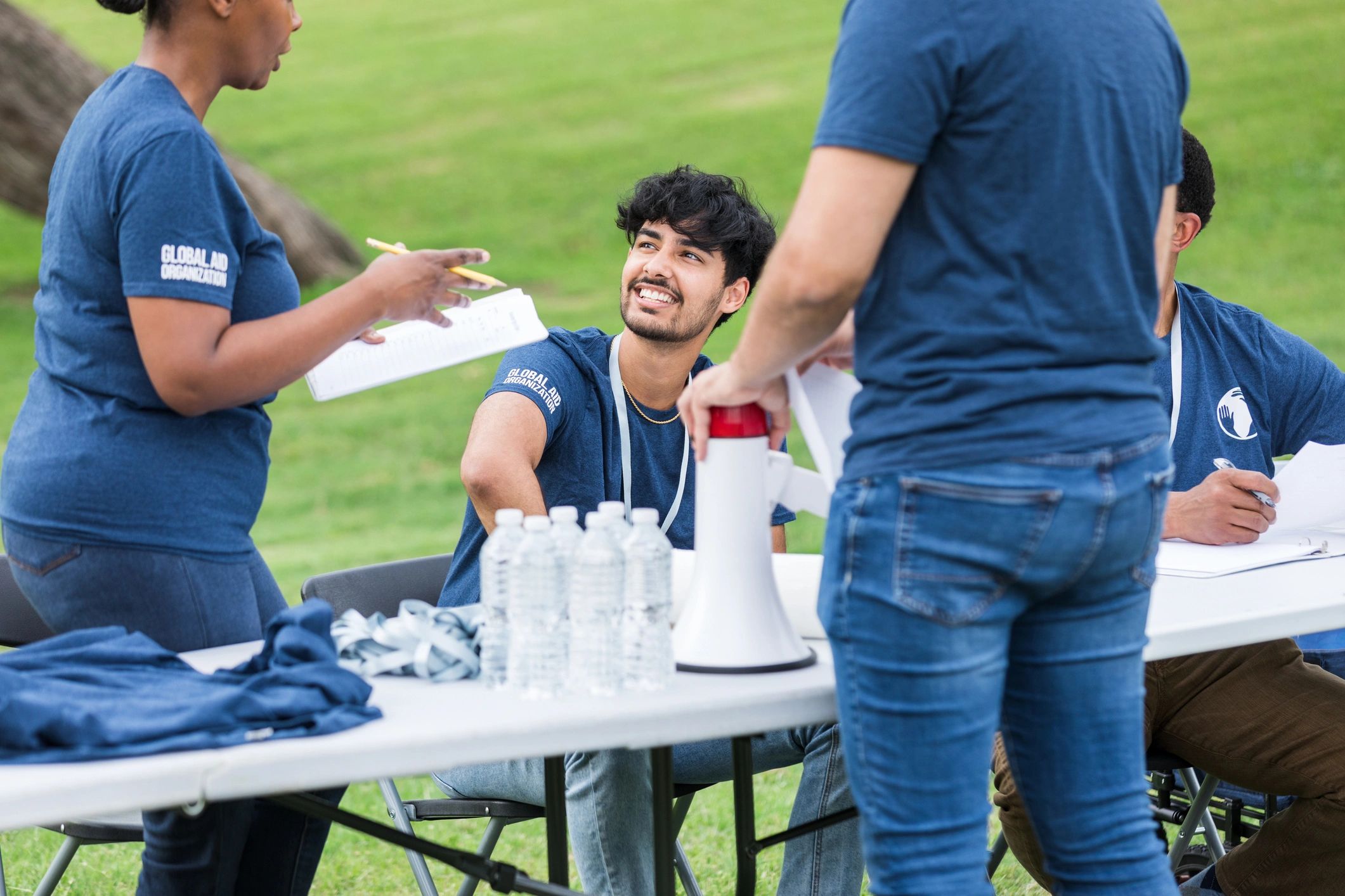 Volunteer leader giving instructions at a registration table