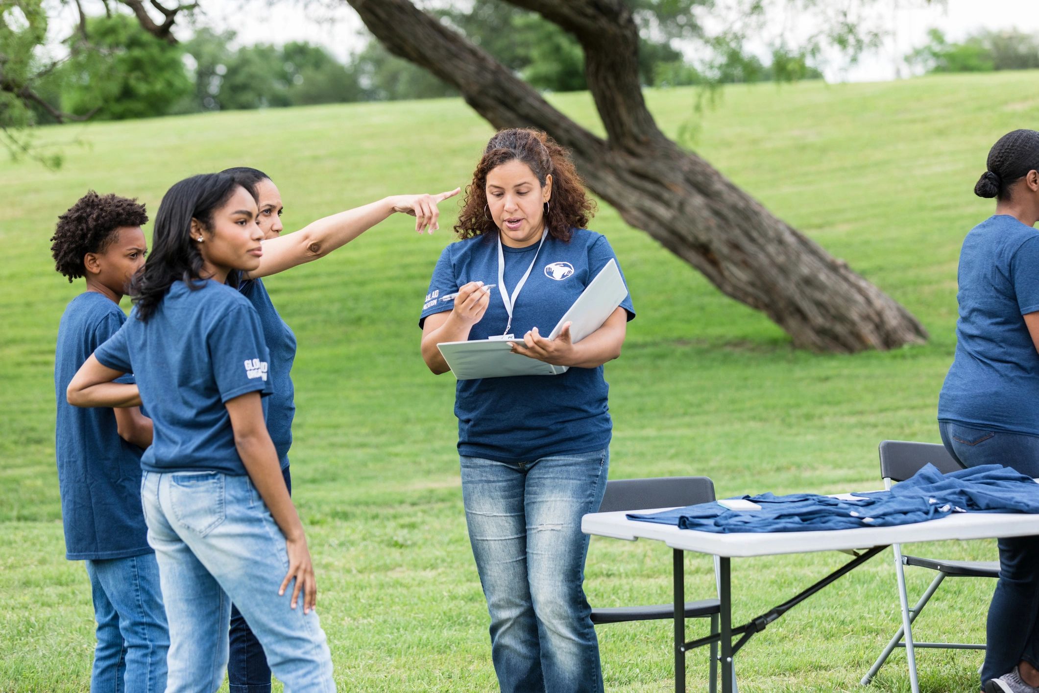 Family speaking with a volunteer leader at a community event