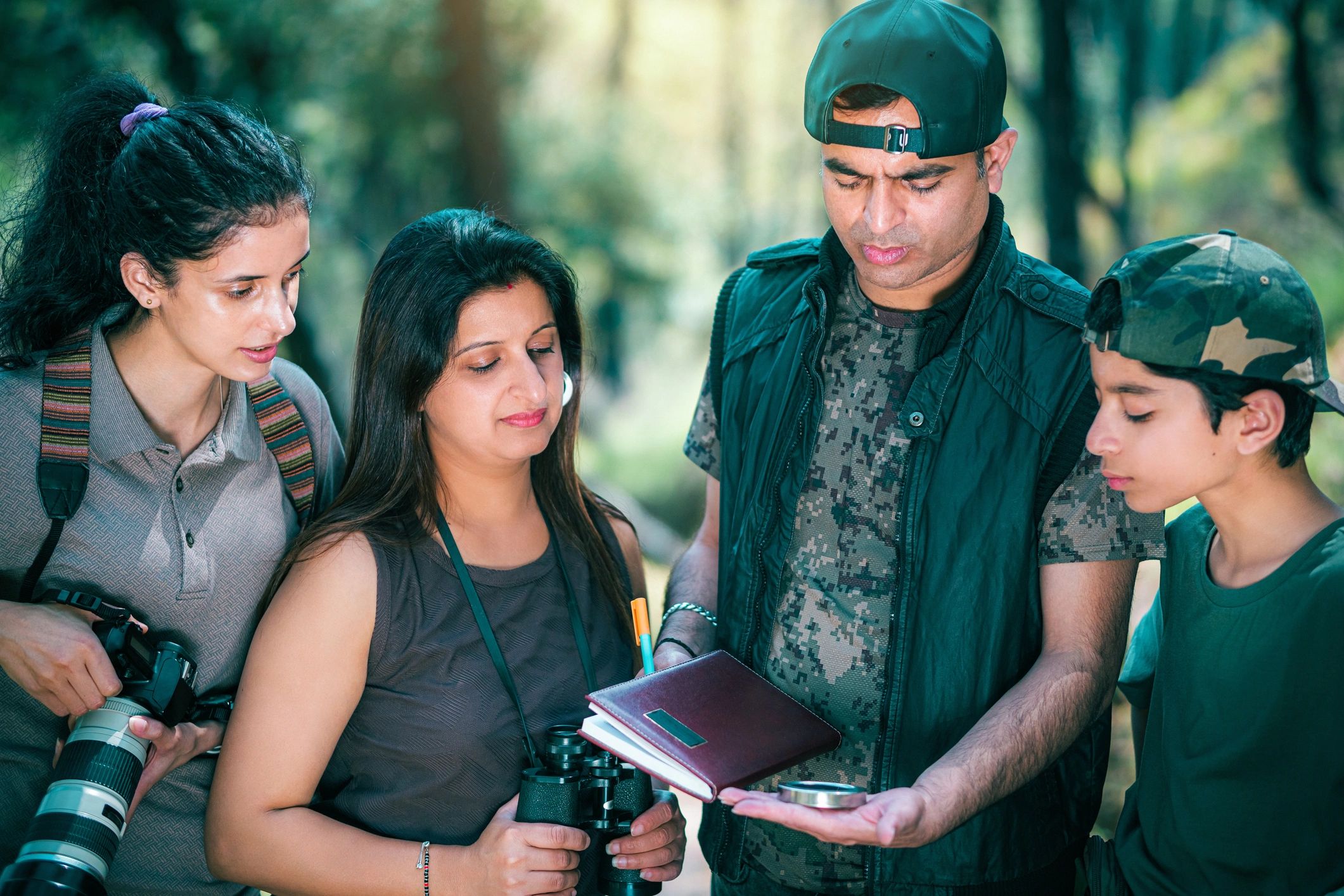 Leader teaching youth navigation skills outdoors