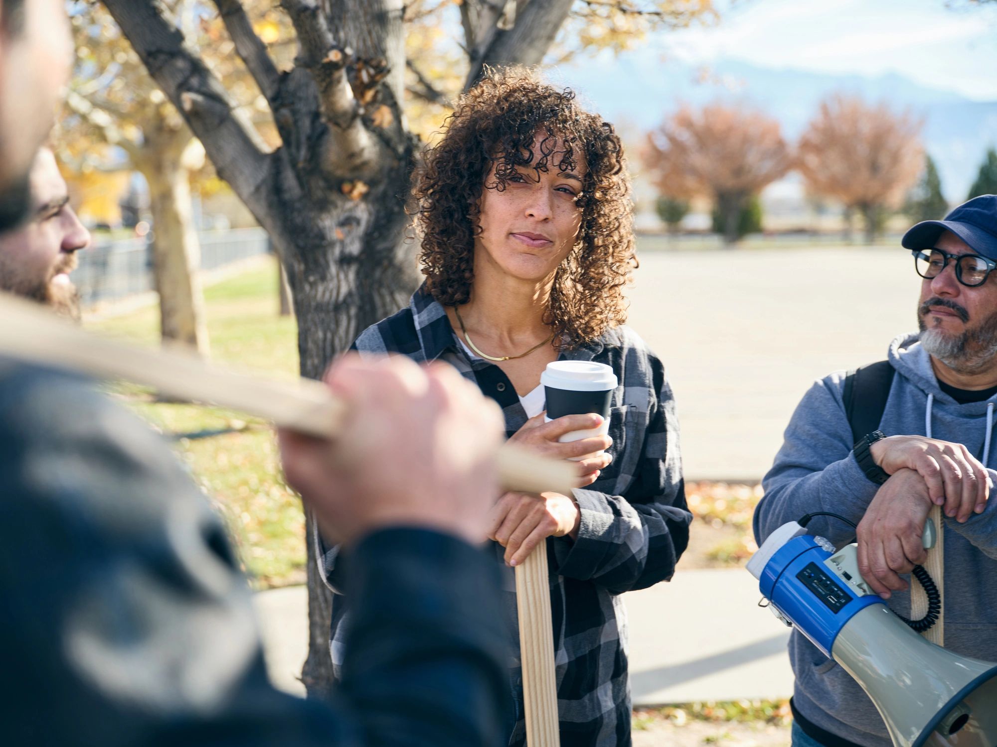 Adults collaborating outdoors while preparing materials for a community project